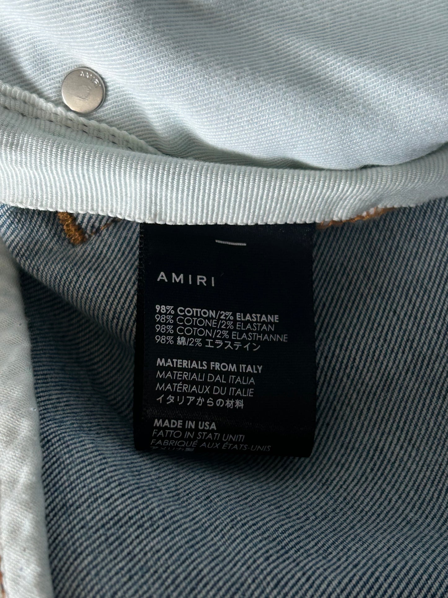 Amiri Clay Indigo White Patch Thrasher Jeans